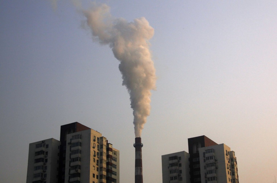 A chimney of a coal burning heating system for apartment blocks billows smoke in central Beijing