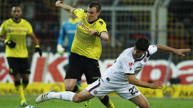 Kaiserslautern's Dick challenges Borussia Dortmund's Grosskreutz during the German first division Bundesliga soccer match in Dortmund