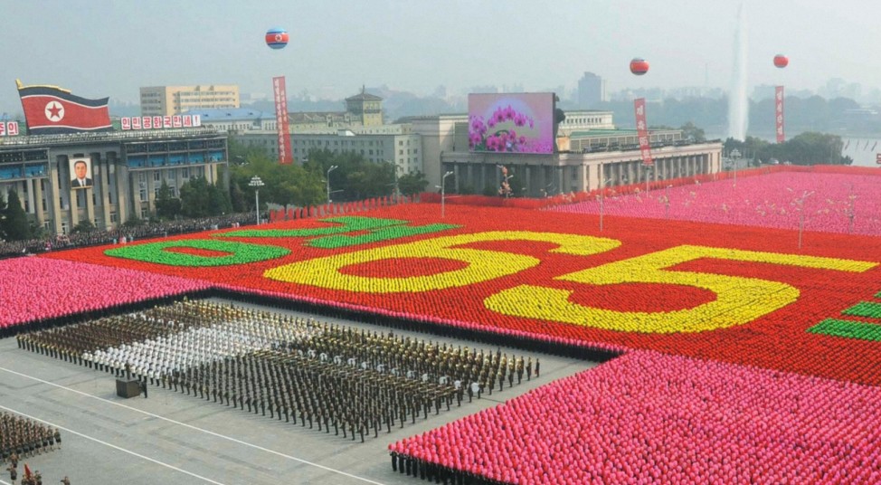 File photo of North Koreans taking part in a parade to commemorate the 65th anniversary of the founding of the Workers' Party of Korea in Pyongyang