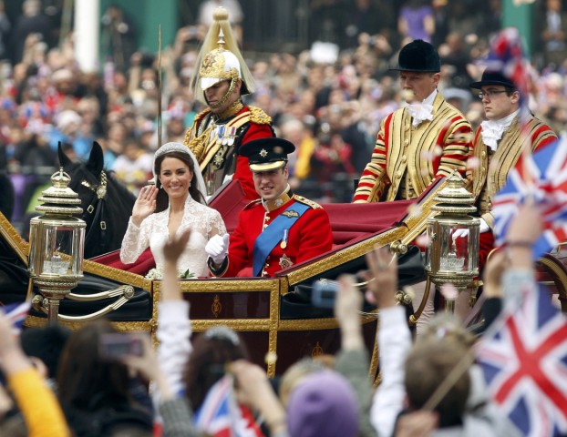 Britain's Prince William and his wife Catherine, Duchess of Cambridge, travel to Buckingham Palace along the Procession Route after their wedding in Westminster Abbey, in central London