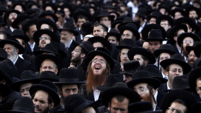 Ultra-Orthodox Jews pray during a protest against the gay pride parade in Jerusalem