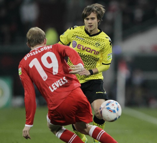 Borussia Dortmund's Loewe is challenged by Fortuna Duesseldorf's Levels during their German soccer cup DFB Pokal match in the western German city of Duesseldorf