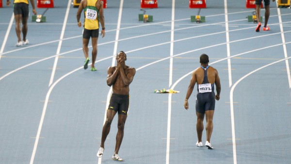 Usain Bolt of Jamaica reacts after being disqualified for a false start during the men's 100 metres final in Daegu