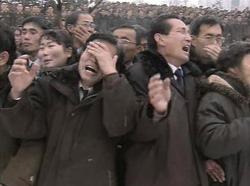 North Koreans react during Kim Jong-il's funeral procession in Pyongyang