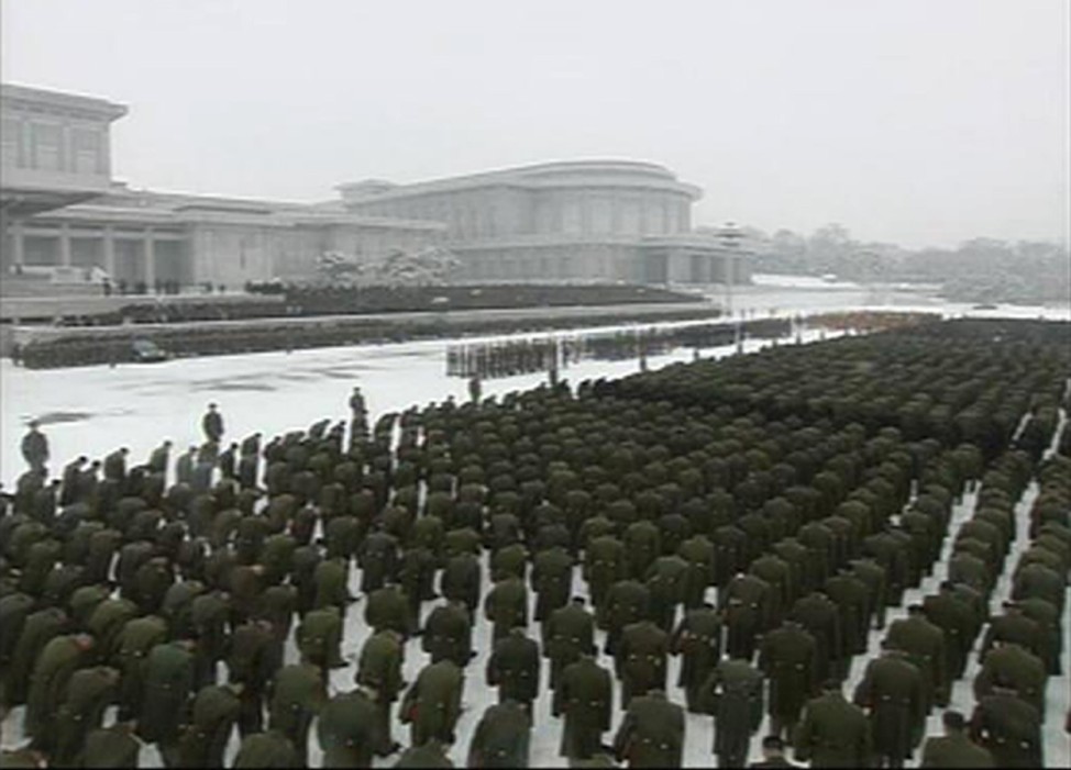 Uniformed personnel stand in formation outside the Kumsusan Memorial Palace during Kim Jong-il's funeral procession in Pyongyang