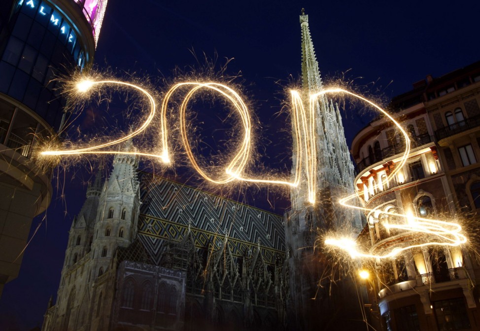 The number 2012 is written with sparklers during a long exposure in front of St. Stephen's Cathedral (Stephansdom) during New Year's Eve celebrations in Vienna