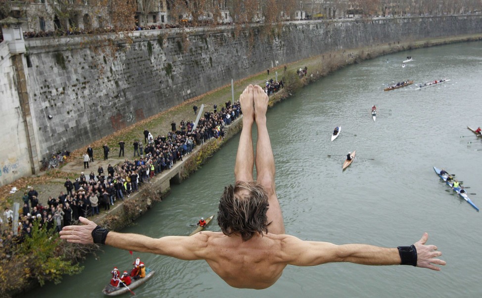 Marco Fois of Italy dives into the Tiber River from the Cavour bridge, as part of traditional New Year celebrations in Rome