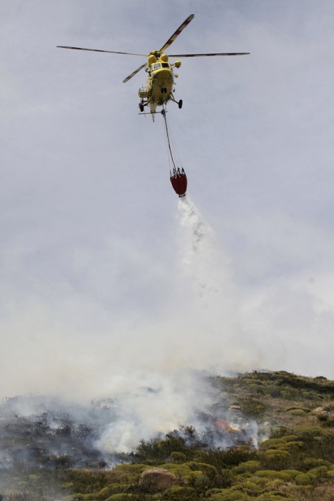 A helicopter releases water over a wildfire at the Chilean Torres del Paine national park in the southern Patagonia region of Chile