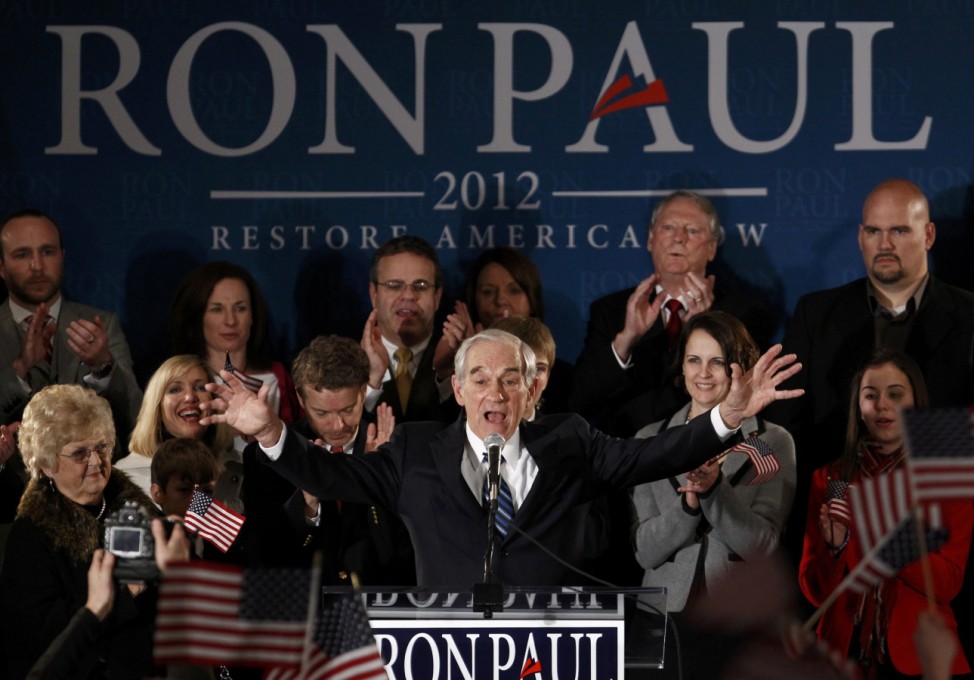 Republican presidential candidate Congressman Ron Paul gestures with both hands as he arrives at his Iowa Caucus night rally in Ankeny Iowa,