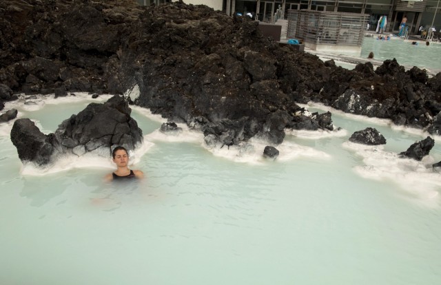 A tourist relaxes in one of the Blue Lagoon mineral pools near Reykjavik