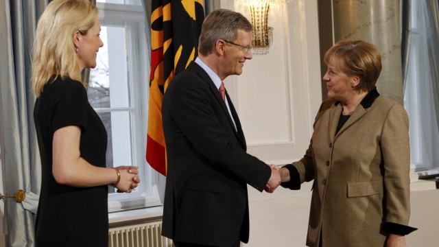 German President Wulff and his wife Bettina welcome Chancellor Merkel during a New Year reception for public life representatives in the presidential Bellevue palace in Berlin