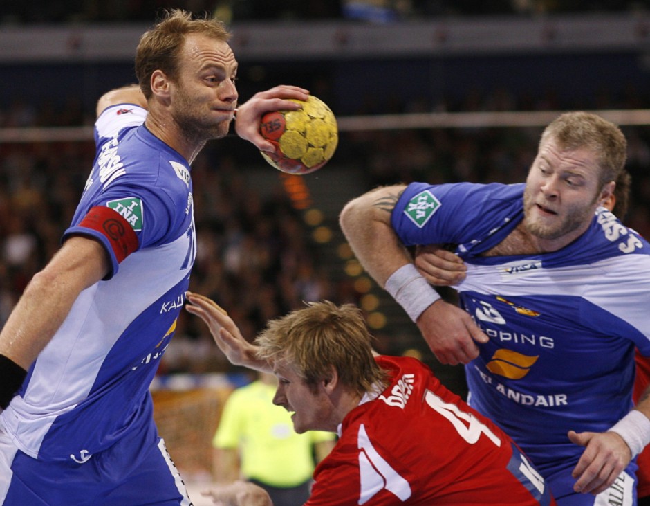 Iceland's Stefansson and Sigurdsson attack Denmark's Boesen during their Handball World Cup quarter-final match in Hamburg