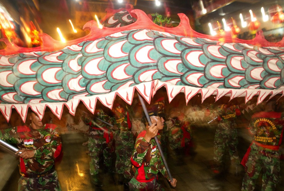 Soldiers perform dragon-dance in front of Tay Kei Sek temple in Semarang