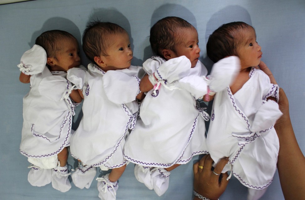 A nurse handles four babies who are born as quadruplets in Stella Maris hospital in Medan, Indonesia's North Sumatra province
