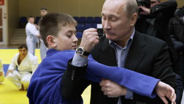 Russian Prime Minister Vladimir Putin instructs a trainee during a judo demonstration at a regional judo centre in the city of Kemerovo