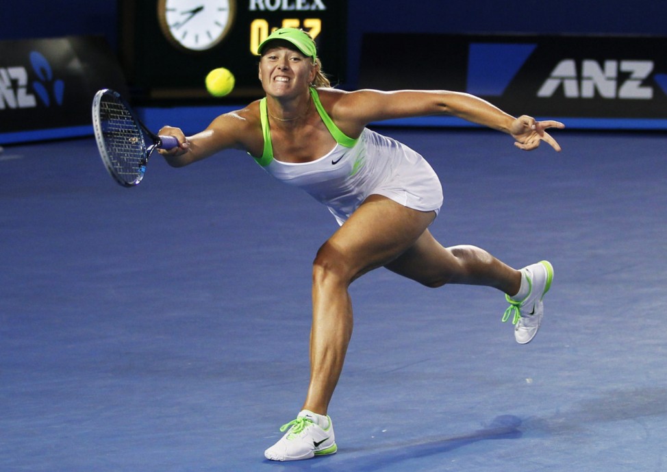 Sharapova of Russia hits a return to Azarenka of Belarus during their women's singles final match at the Australian Open tennis tournament in Melbourne