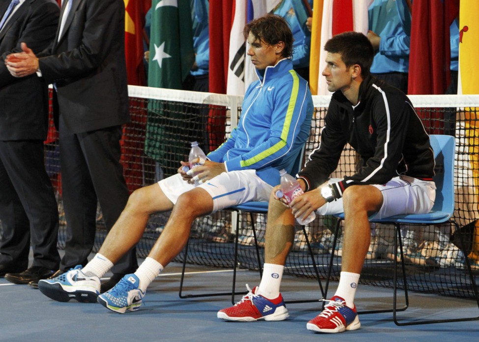 Djokovic of Serbia and Nadal of Spain sit as they wait for trophy presentation after their final match at the Australian Open in Melbourne