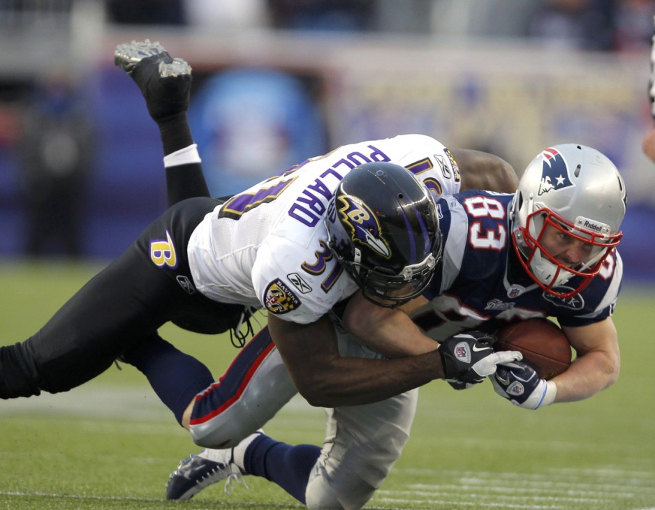 Baltimore Ravens strong safety Bernard Pollard tackles New England Patriots wide receiver Wes Welker during their NFL AFC Championship football game in Foxborough