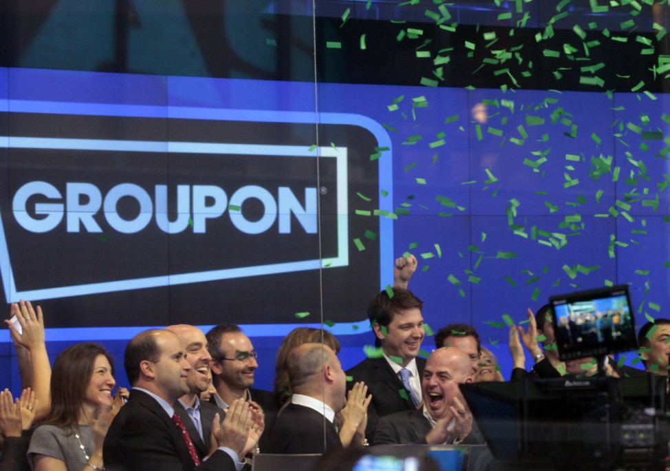 Employees and guests of Groupon ring the opening bell in celebration of the company's IPO at the Nasdaq Market in New York