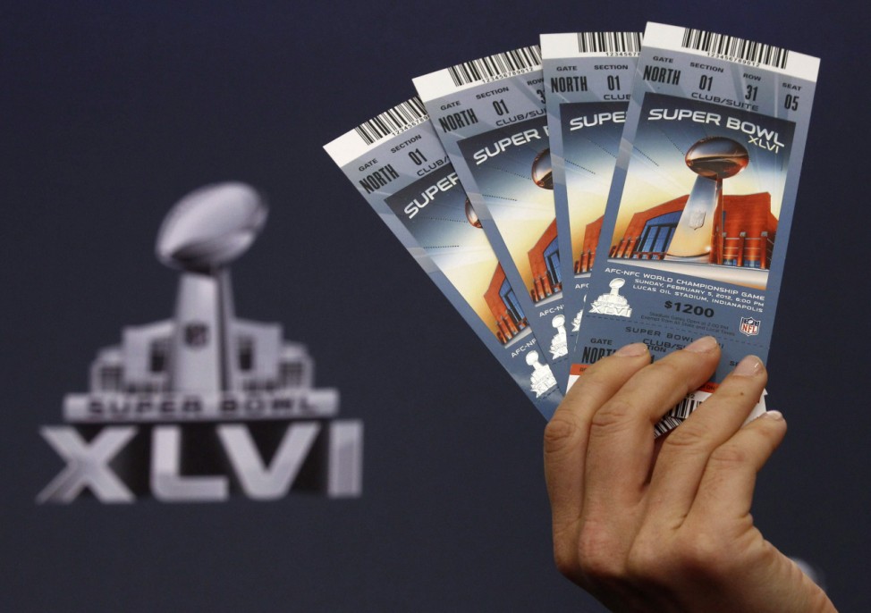 Samples of legitimate tickets for NFL Super Bowl XLVI are held up by NFL Vice President for Legal Affairs Danias during a news conference on counterfeit merchandise in Indianapolis