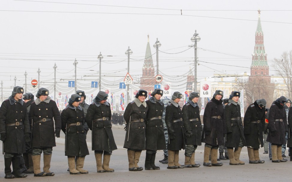 Police officers form a cordon across a road during a demonstration for fair elections in central Moscow