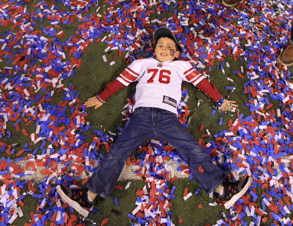 The son of New York Giants guard Chris Snee makes confetti angels after the Giants defeated the New England Patriots