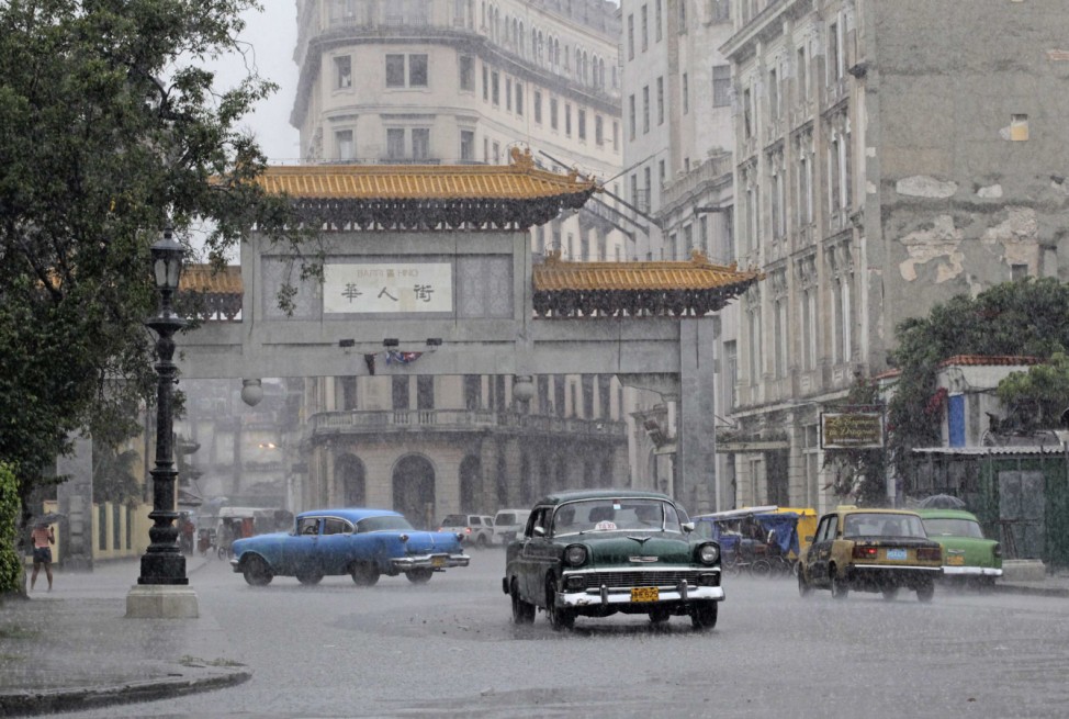 Traffic passes by the entrance to Havana's Chinatown