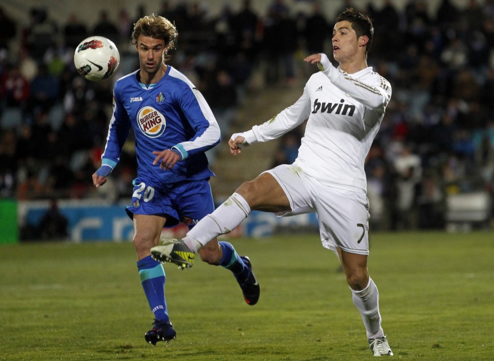 Real Madrid's Ronaldo and Getafe's Valera fight for the ball during their Spanish First Division soccer match in Getafe