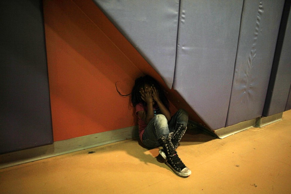 A girl, who is homeless, takes a break in the gym at the Union Rescue Mission shelter in Los Angeles