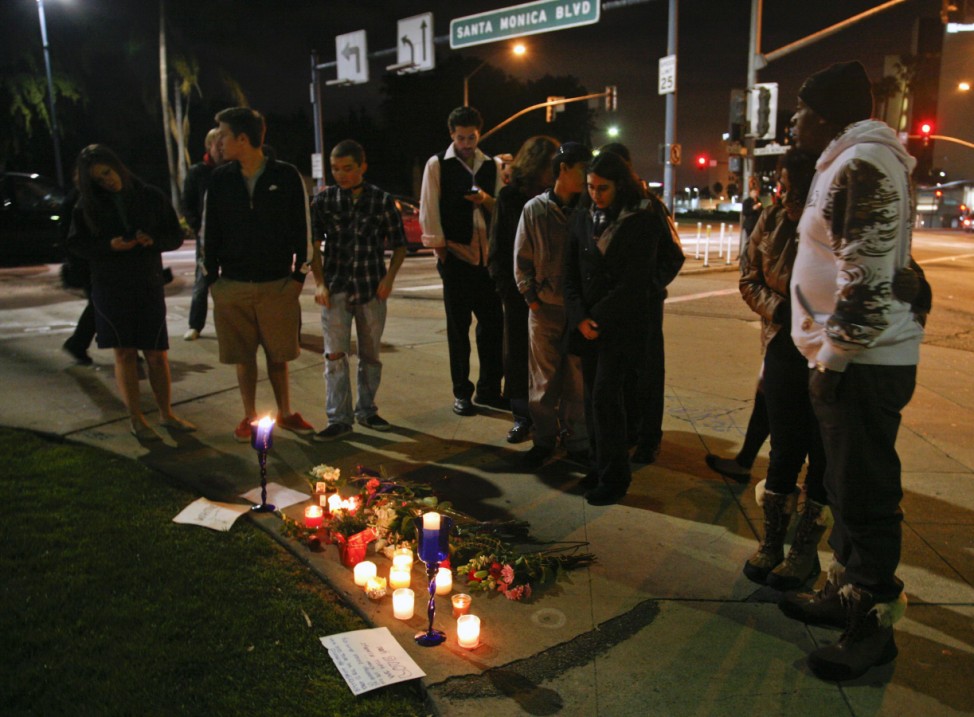 People gather at makeshift memorial on corner of Santa Monica and Wilshire Boulevard to mourn death of singer Whitney Houston in Beverly Hills