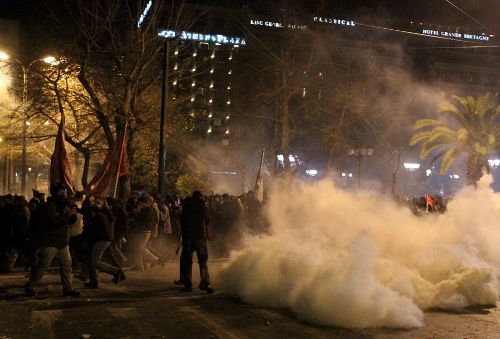 Protesters clash with riot police outside of the Greek Parliament