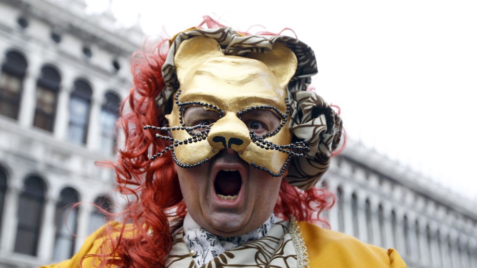 A masked reveller poses in Saint Mark's Square during the Venetian Carnival in Venice