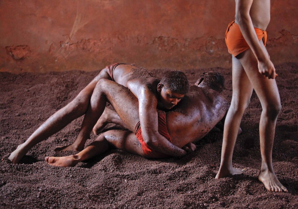 Wrestlers practise in the mud at a traditional mud wrestling (Kushti) centre called Akhaara in Kolhapur