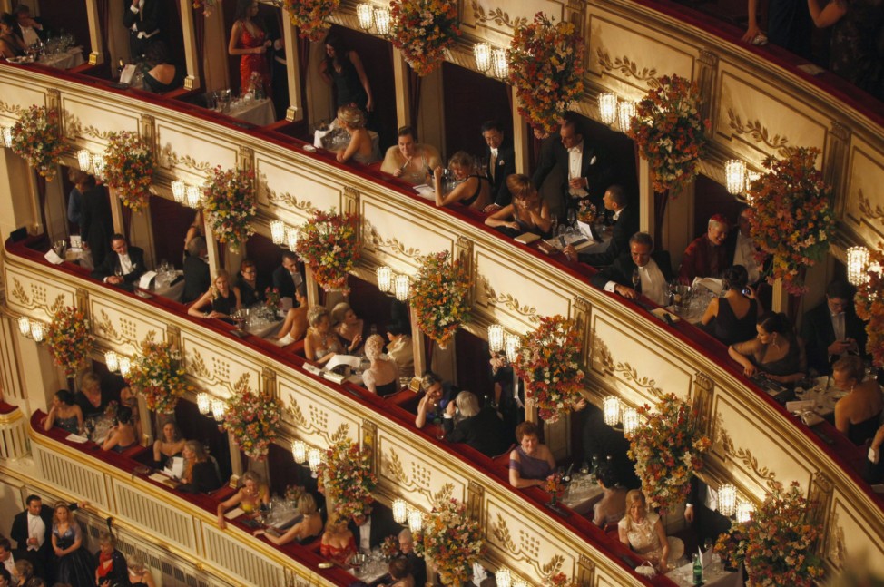 People sit in their boxes at the Vienna State Opera House during the traditional Opernball in Vienna