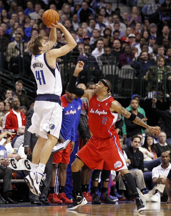 Dallas Mavericks forward Nowitzki shoots over Los Angeles Clippers forward Martin during the second half of their NBA basketball game in Dallas, Texas