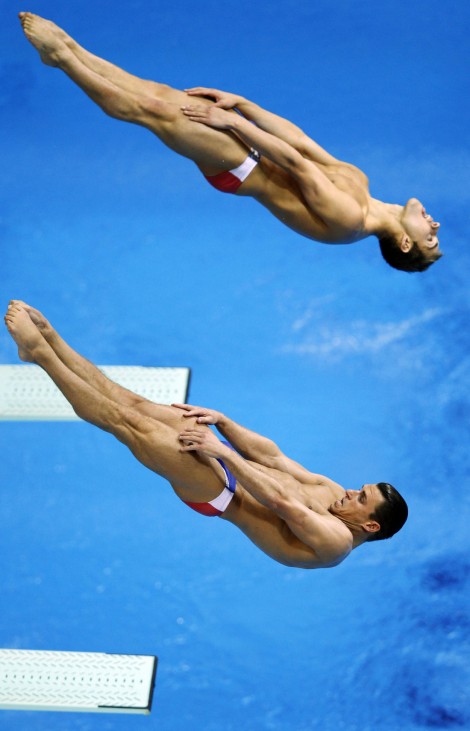 Troy Dumais and Kristian Ipsen from the U.S. dive during the Men's Synchronised 3m Springboard preliminary round at the FINA Diving World Cup at the Olympic Aquatics Centre in London