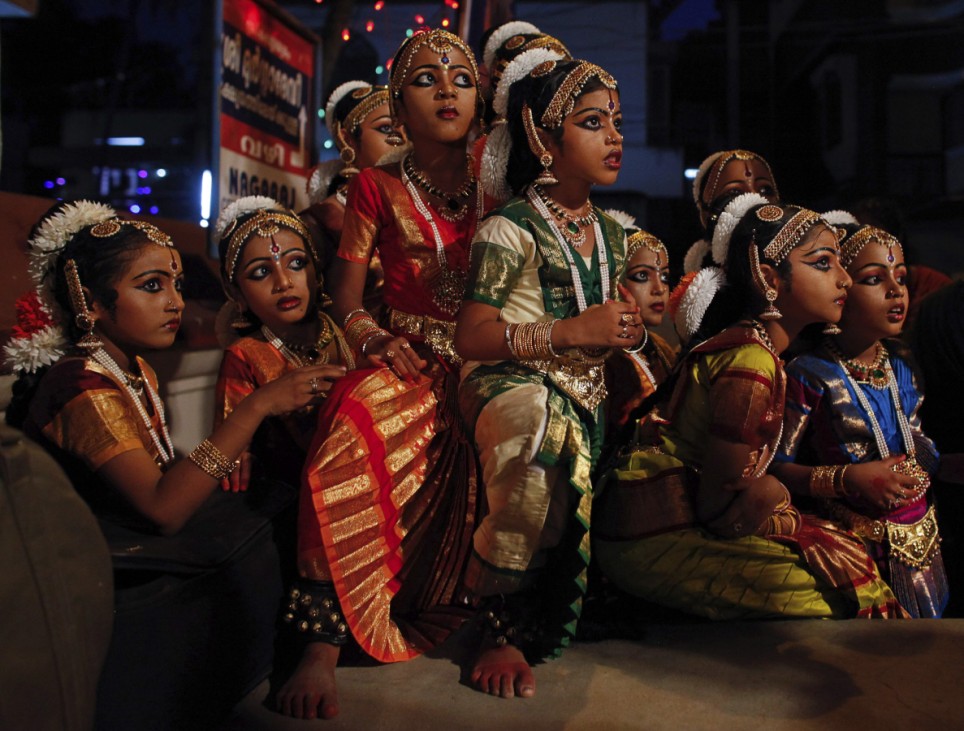 School girls watch backstage a performance of Indian classical dance on the occasion of Mahashivratri festival in Thiruvananthapuram