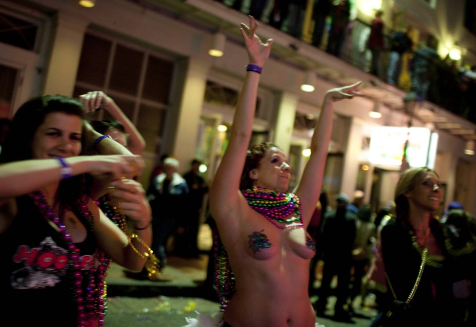 People celebrate on Bourbon Street as part of the Mardi Gras celebration in the French Quarter of New Orleans
