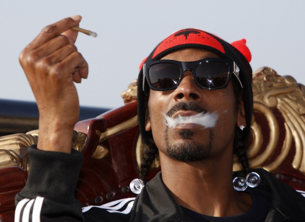 File photo of U.S. rapper Snoop Dogg exhaling cigar smoke as he poses before the 'Isle of MTV Malta Special' concert in Floriana, outside Valletta
