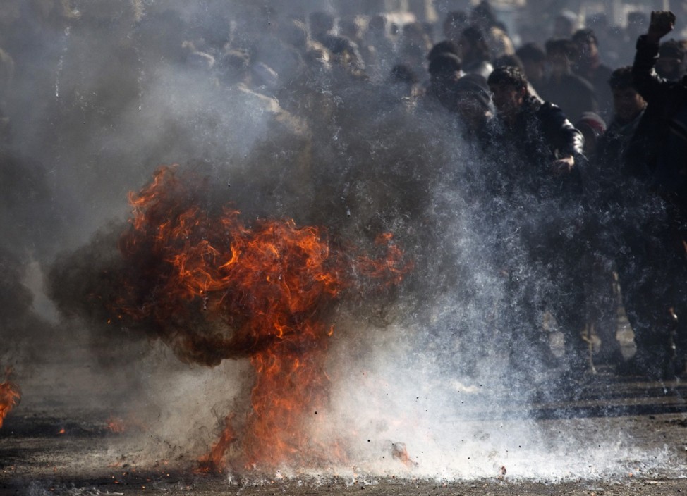 Fuel burns as Afghans protest near a U.S. military base in Kabul