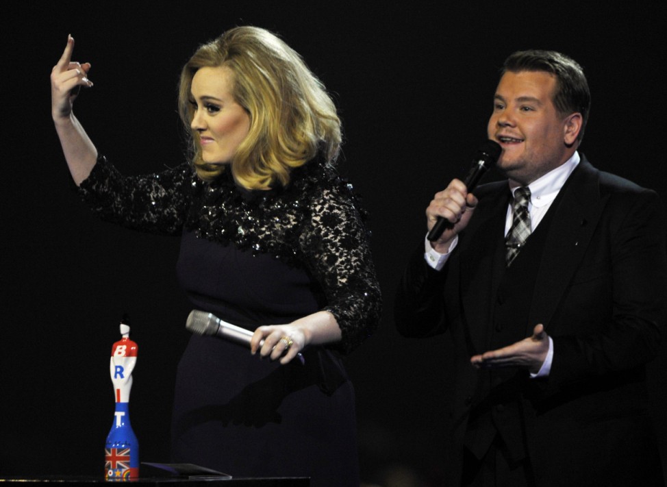 Adele gestures after being interrupted, following her award for best British album of the year during the BRIT Music Awards at the O2 Arena in London