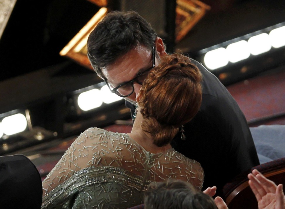 French Director Hazanavicius kisses his wife Bejo after winning the Oscar for best director for his film 'The Artist' at the 84th Academy Awards in Hollywood