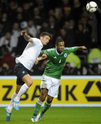 Germany's  Aogo challenges Giroud of France during their international friendly soccer match in Bremen.
