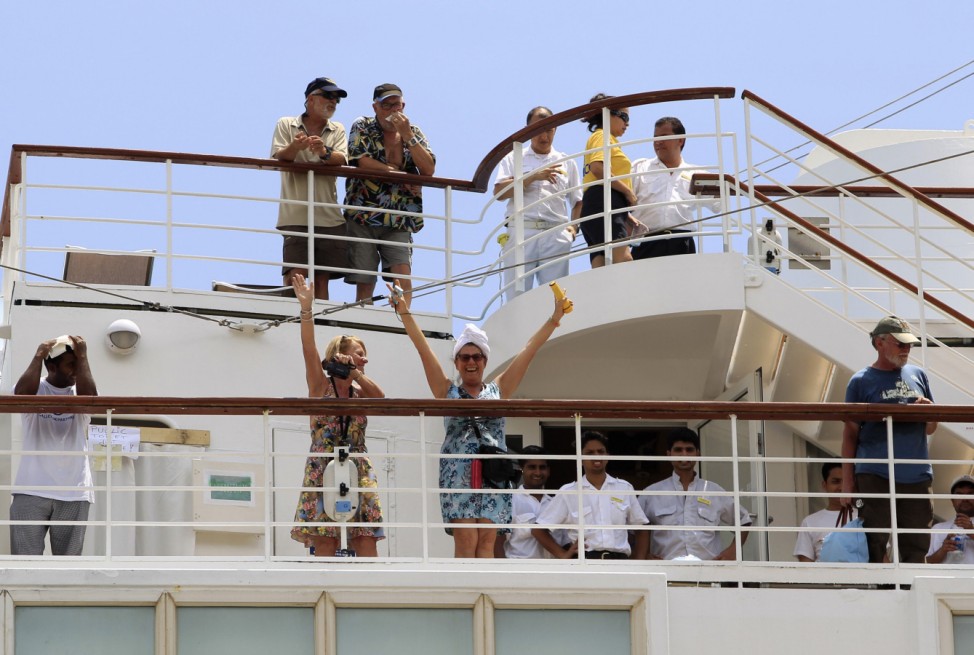 Passengers wave as the Costa Allegra cruise ship arrives in Seychelles Island