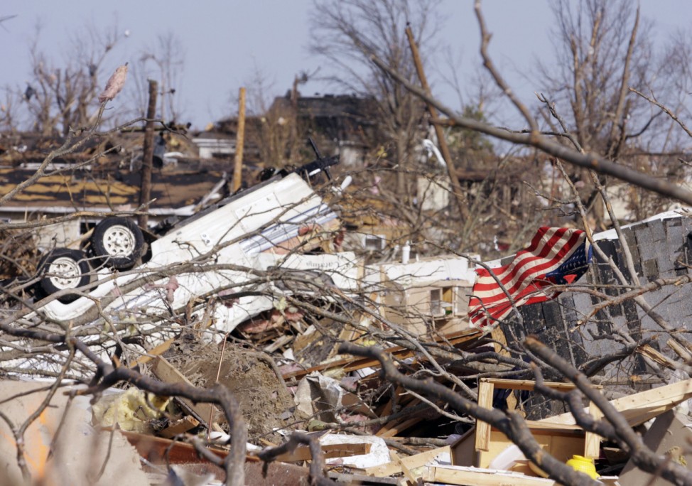 An American flag is snagged amongst the debris after a tornado struck in Harrisburg, Illinois