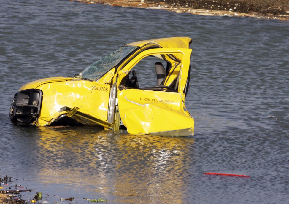 The cab of a truck is submerged in the middle of a pond after being deposited there by a tornado in Harrisburg, Illinois