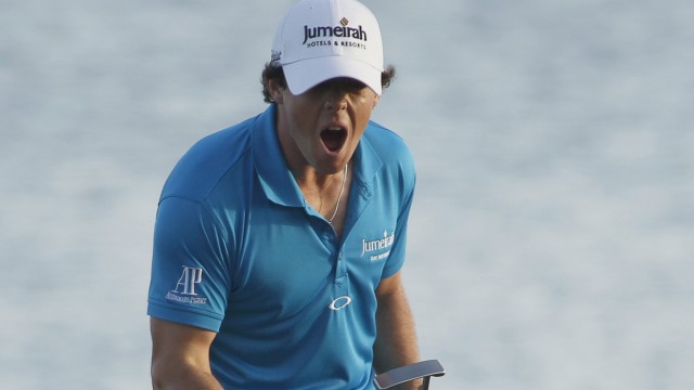 Rory McIlroy of Northern Ireland reacts after becoming golf's new world number one player on the 18th green with his win in the Honda Classic PGA golf tournament at PGA National Golf Club in Palm Beach Gardens