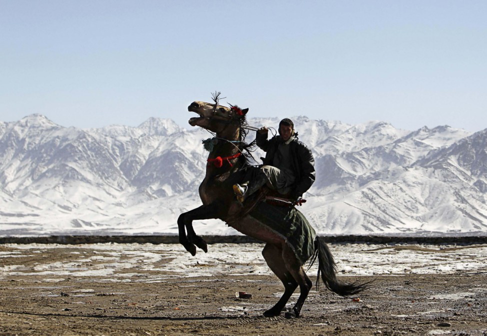 A man rides his horse on a hilltop in Kabul