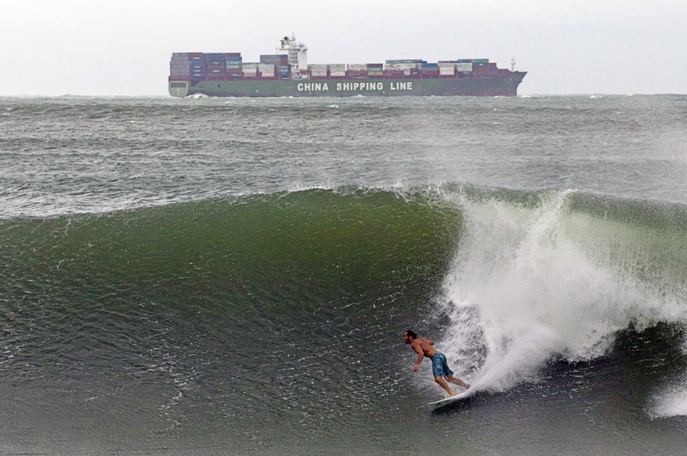 A surfer takes advantage of large waves caused by hurricane Irina which is sitting some 200 nautical miles off Durban