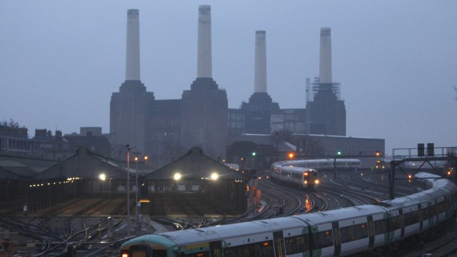 Trains travel to and from Victoria station past Battersea Power Station in central London
